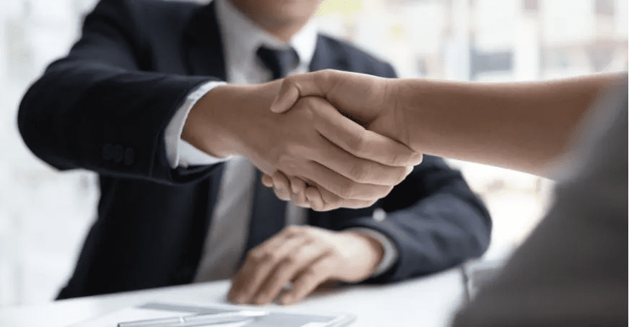 Business owner shaking hands with a financial advisor after discussing bookkeeping and CFO advisory services